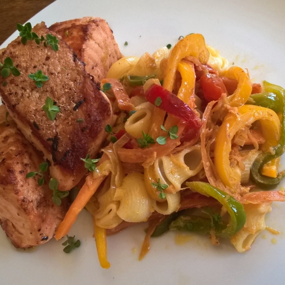 Salmon tenderloin with sauteed pasta peppers cherry tomatoes and leeks